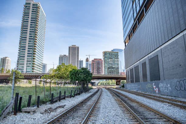 Train tracks in the West Loop area, downtown Chicago, IL - September 7. 2019: Train tracks in the West Loop area, downtown, in the Fulton Market District neighborhood, where the beautiful city skyline is visible. major us cities stock pictures, royalty-free photos & images