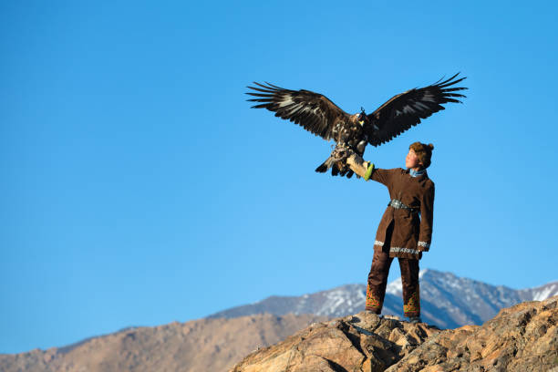 istock Young kazakh eagle hunter with her golden eagle. 1177965707