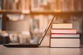 istock Bookshelves and laptops are placed on the library desk.E-learning class and e-book digital technology 1177967778