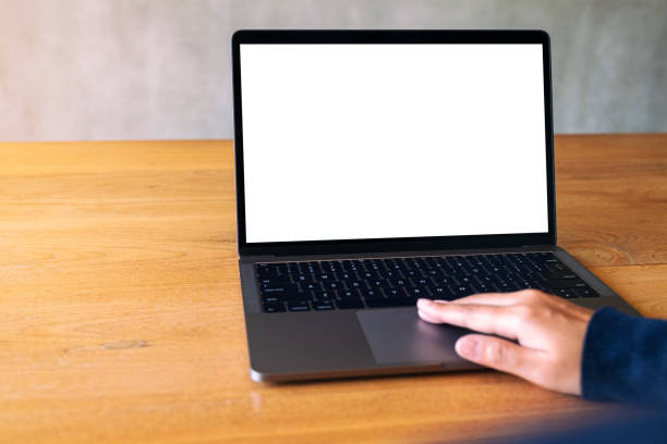 istock a hand using and touching on laptop touchpad with blank white desktop screen on wooden table 1177969603