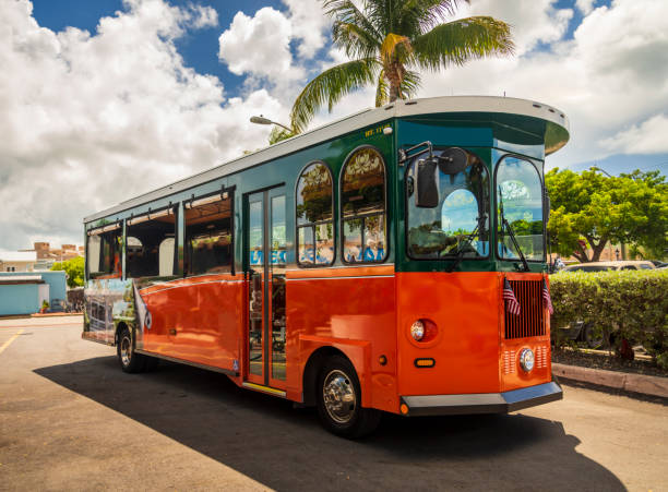 Historic Trolley Buses of Key West, Florida Tourists  travel on historic, orange Trolley Buses of Key West, Florida trolley bus stock pictures, royalty-free photos & images