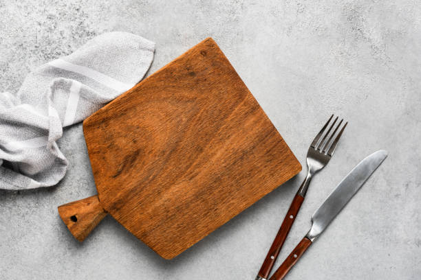 istock Wooden cutting board and cutlery 1177980469