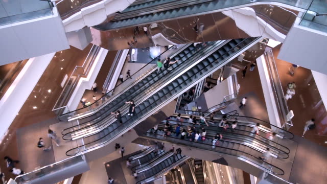 Time lapse escalators in modern shopping mall crowd of people