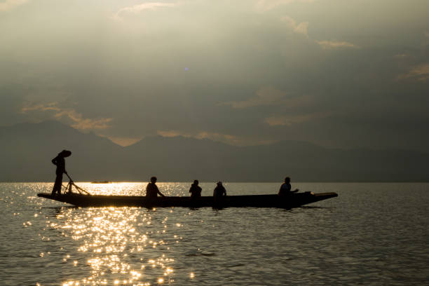 istock sunset on the lake, boat silhouette 1177995055