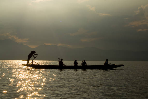 istock sunset on the lake, boat silhouette 1177995084