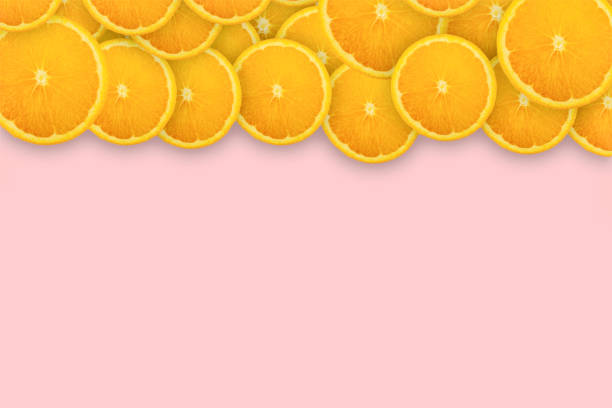 istock Slices of orange on pink background. Background and pattern concept 1177999685