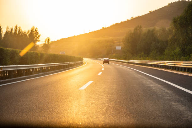istock Sunset on straight country road 1178000667