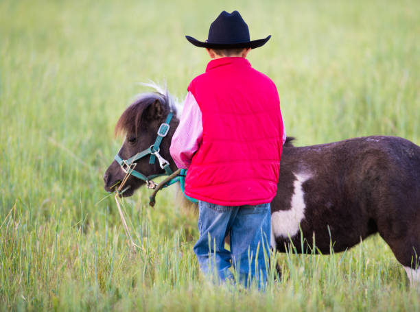 istock Little cowboy with a pony horse 1178001769