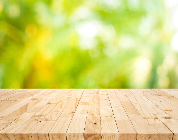 istock Real wood table top texture on blur fresh green garden background 1178002967