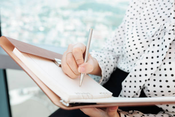 istock Businesswoman writing down plans 1178004429