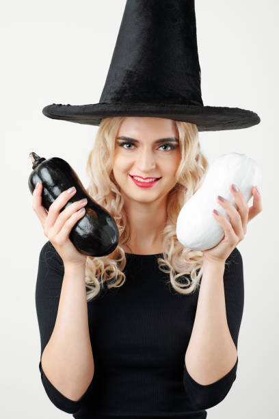 istock Happy woman in witch hat showing zuccini 1178004635