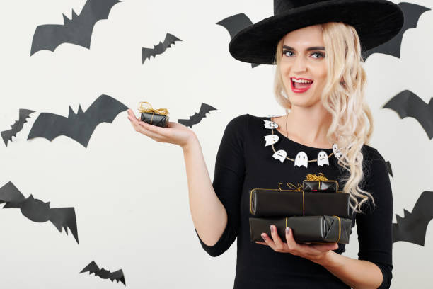 istock Happy witch with Halloween gifts and presents 1178004668