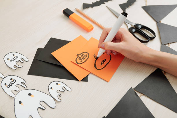 Creative woman drawing Halloween symbols