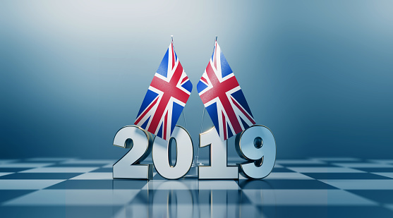 British flag pair and 2019 on a chess board. Horizontal composition with copy space and selective focus. 2020 snap elections concept.