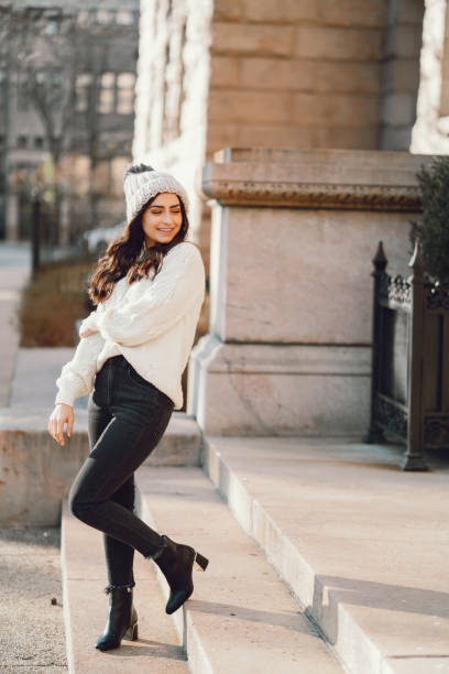 istock Cute brunette in a white sweater in a city 1178009310