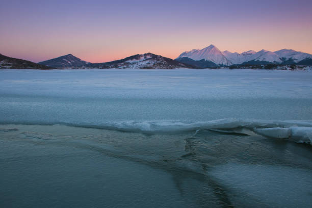 istock Winter landscape with frozen lake at sunset 1178009342