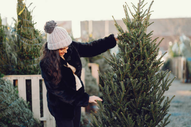 istock Cute brunette in a white sweater with Christmas tree 1178009358