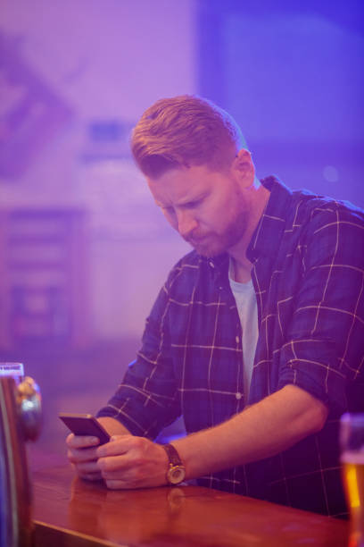 istock Worried young man texting at the bar counter 1178009760