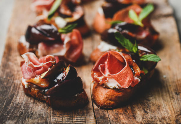 istock Crostini with prosciutto, goat cheese and grilled figs on board 1178010638