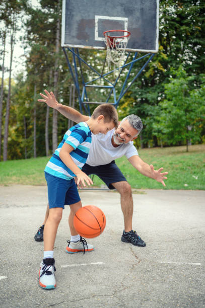 istock Father and son playing basketball 1178010884