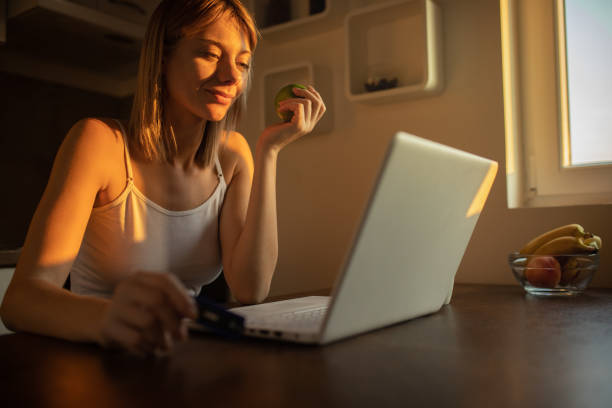 istock Young woman working on laptop at home 1178015935