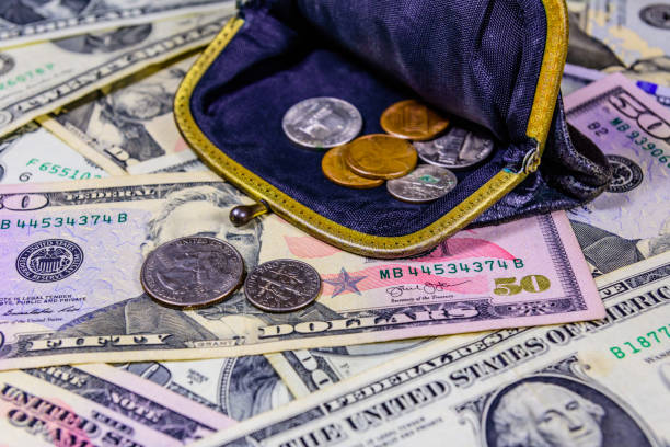 istock Old wallet with american cent coins over the dollar banknotes 1178017727