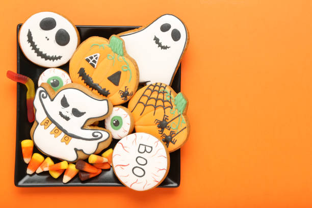 istock Halloween gingerbread cookies with candies on orange background 1178017989