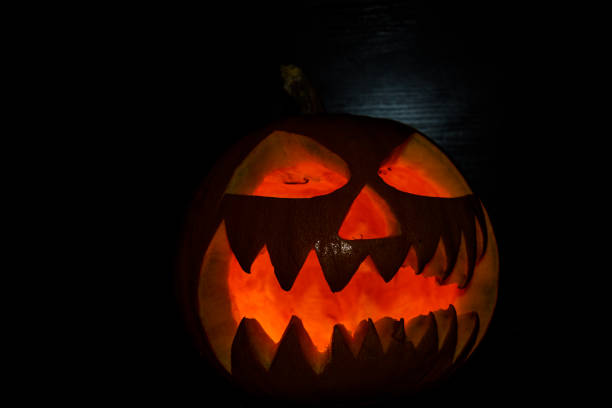 istock Spooky halloween pumpkin on a black background 1178018012