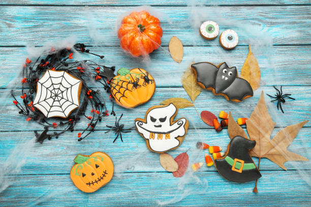 istock Halloween gingerbread cookies with dry maple leafs on blue wooden table 1178018066