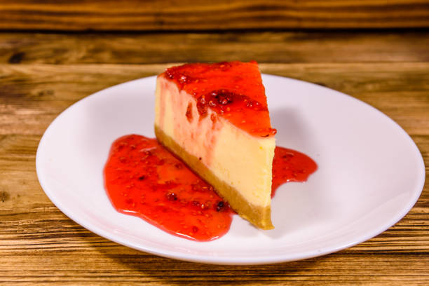 istock White plate with cheesecake New York and raspberry jam on wooden table 1178018210