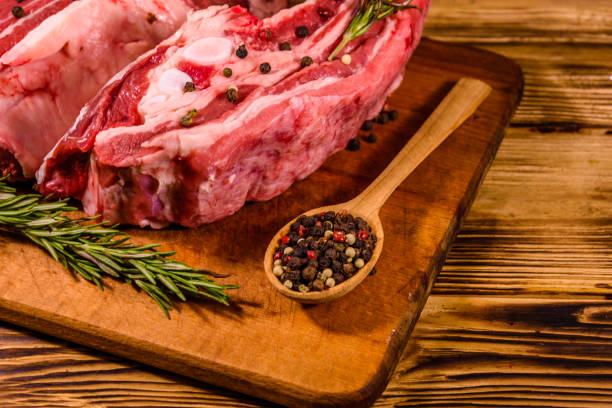 istock Raw pork ribs with spices and rosemary on a cutting board 1178018283
