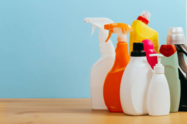 istock Cleaning product plastic container for house clean on wooden table and blue background . 