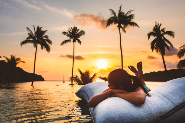 istock Asian woman relax in pool on beach 1178019542