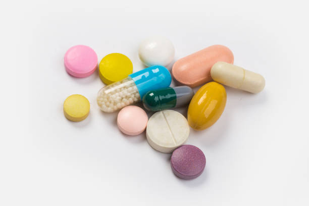istock Assorted pharmaceutical medicine pills, tablets and capsules.Heap of assorted various medicine tablets and pills different colors on white background. 1178019765