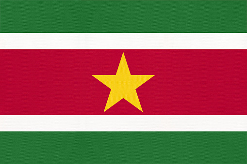 Suriname national fabric flag, textile background. Symbol of international south America world country. State official sign.