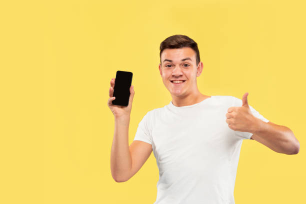 istock Caucasian young man's half-length portrait on yellow background 1178020693