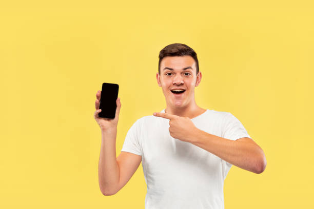 istock Caucasian young man's half-length portrait on yellow background 1178020704
