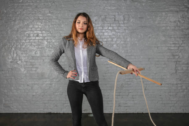istock business woman holds puppet lines in hands 1178021032