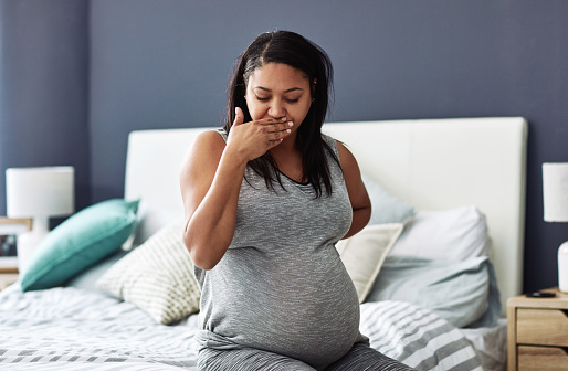 Cropped shot of a pregnant woman feeling nauseous