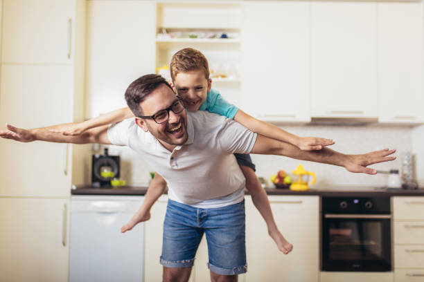 istock Smiling man piggybacking his son at home 1178023259