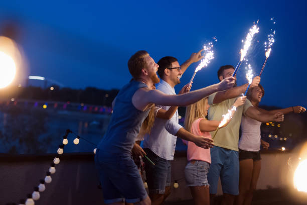 istock Group of young people having fun at a summertime party, at sunset 1178024649