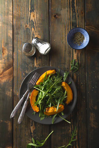 Autumn salad of fresh arugula and baked pumpkin