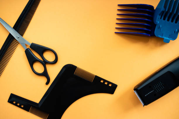 istock Barber set with scissors, comb, electric razor and heards on yellow background. Flat lay 1178031614