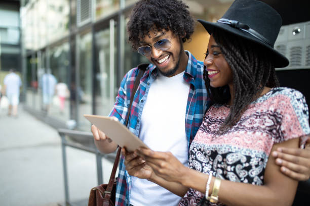 istock Young modern stylish couple using tablet in urban city 1178033538