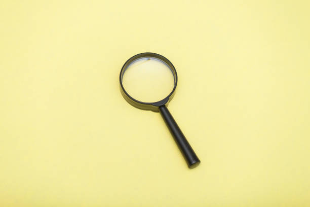 istock Magnifying glass on yellow background, flat lay, copy space. 1178033981