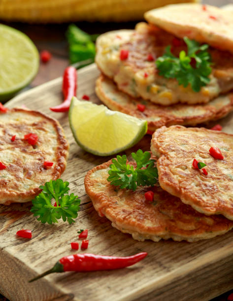 istock Corn fritters, pancake with dip white sauce, lime and chilli on wooden board 1178034912