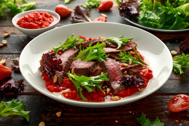 istock Beef Steak with Romesco sauce, nuts and vegetables on white plate 1178035360