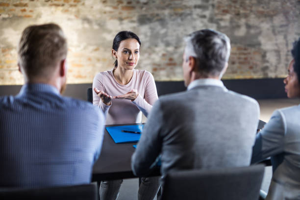istock Young female candidate talking to business team on a job interview. 1178036362