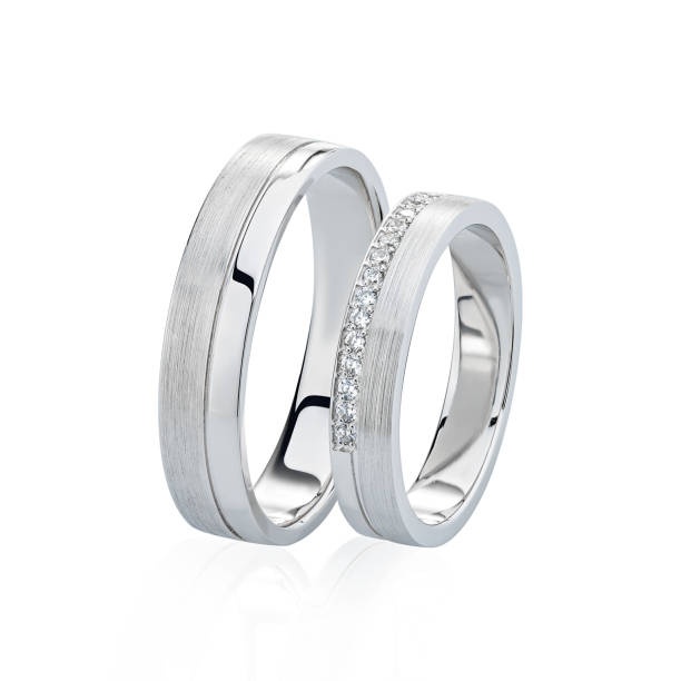 istock Pair of white gold wedding rings with diamonds isolated on white background 1178037018