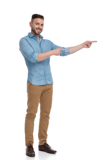 istock casual man standing and pointing sideways happy 1178037766